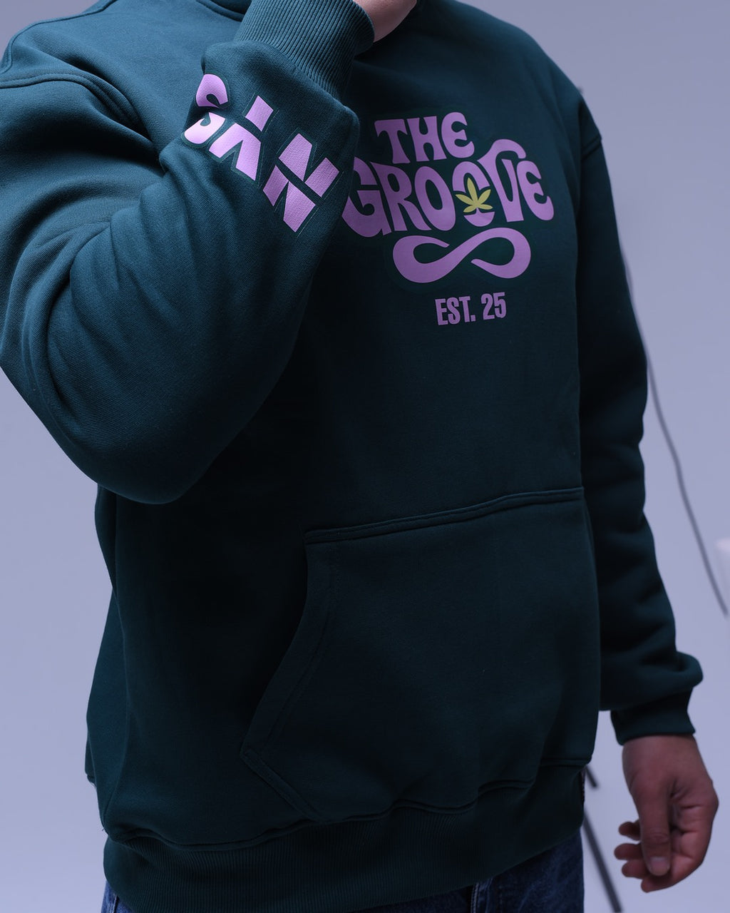 NYS oversized hoodie for unisex in dark color with pink graphic text and a front pocket